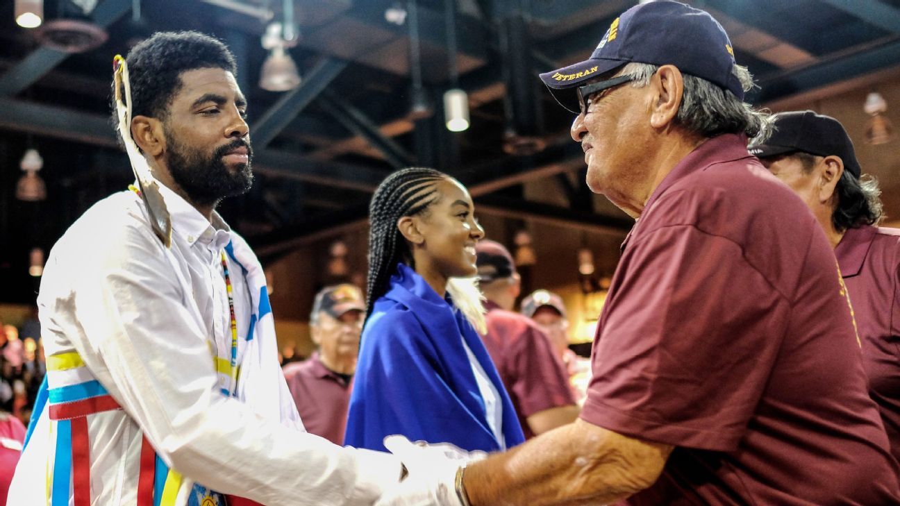 A modern honoring ceremony where an Afro-Indigenous man in ceremonial dress is welcomed by tribal elders